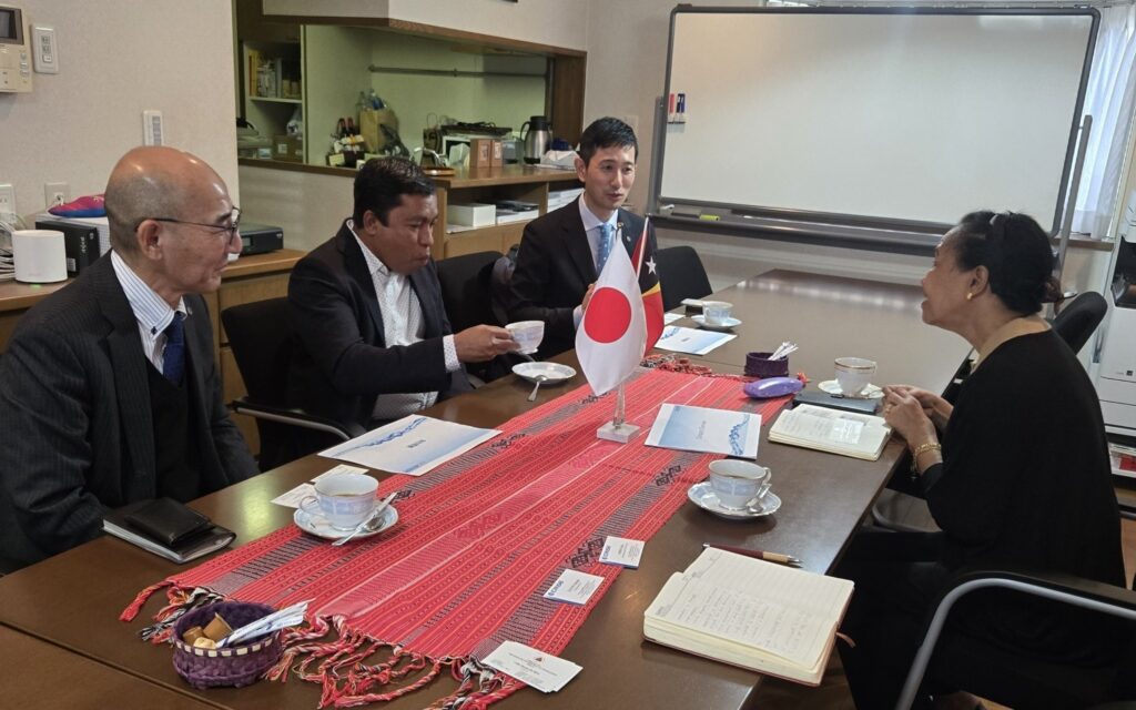 If you upload the photo, use alt text like: "Ambassador Maria Viegas with Director General Suzuki and Mr. Simão Barreto at the Embassy in Tokyo