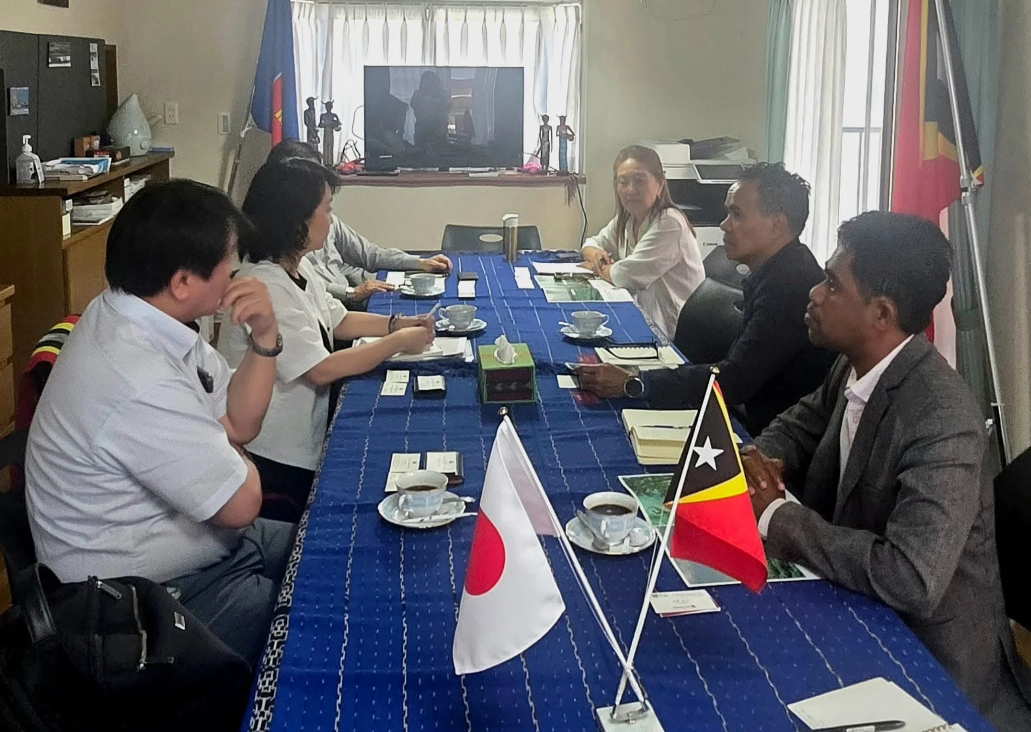 Meeting at the Embassy of Timor-Leste in Japan with representatives of iA-FOODS and Global Media Corporation, Japanese and Timor-Leste table flags side by side