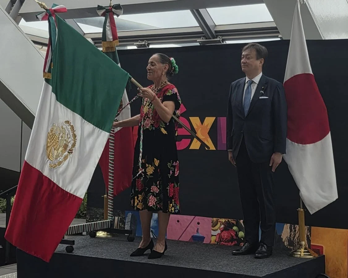 H.E. Ambassador Melba Pría holding the national flag of Mexico during the official ceremony