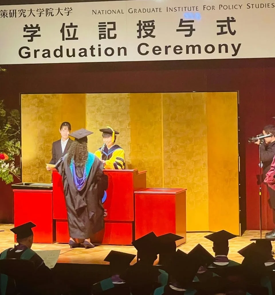 Ms. Freitas receiving her diploma on stage